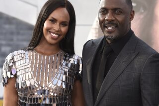 FILE - In a Saturday, July 13, 2019 file photo, cast member Idris Elba, center, arrives with his wife Sabrina Dhowre Elba, left, and Isan Elba, right, at the Los Angeles premiere of "Fast & Furious Presents: Hobbs & Shaw", at the Dolby Theatre. Idris Elba says he and his wife had their lives “turned around” after contracting the coronavirus. (Photo by Jordan Strauss/Invision/AP, File)