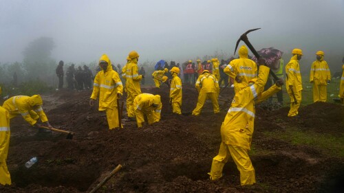 Rescuers dig graves to bury the bodies of victims at the site of a landslide in Raigad district, western Maharashtra state, India, Thursday, July 20, 2023. While some people are reported dead many others feared trapped under piles of debris. (AP Photo/Rafiq Maqbool)