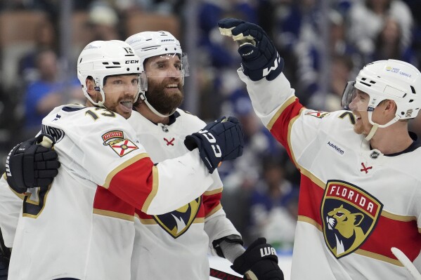 Florida Panthers centre Sam Reinhart (13) celebrates his goal with teammates Aaron Ekblad (5) and Gustav Forsling (42) during the third period of Game 7 of a second-round NHL hockey playoff series in Toronto, Sunday, May 18, 2025. (Frank Gunn/The Canadian Press via AP)
