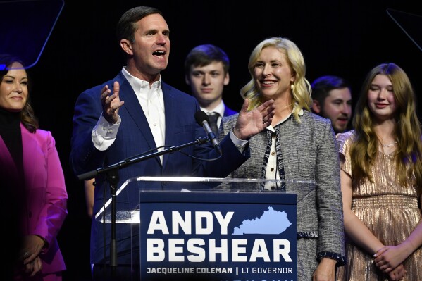 CORRECTS SPELLING OF FIRST NAME OF BRITAIN AND NOT BRITISH - Kentucky Gov. Andy Beshear speaks at a campaign night rally after being elected to a second term in Louisville, Ky., Tuesday, Nov. 7, 2023. AT right is his wife Britainy Beshear.  (AP Photo/Timothy D. Easley)