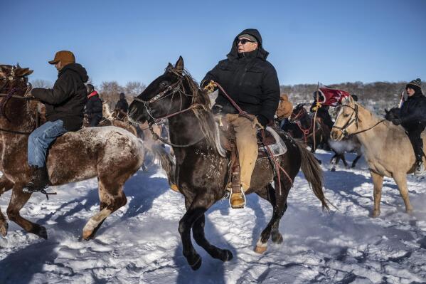 Riders on their last leg of the journey from South Dakota take off from Land of Memories to Reconciliation Park in Mankato, Minn., Monday, Dec. 26, 2022. (Jerry Holt/Star Tribune via AP)