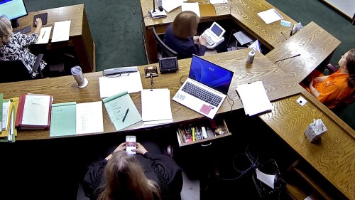 In this still image from security camera video, Lincoln County District Judge Traci Soderstrom looks at her cellphone during a murder trial on June 12, 2023, at the Lincoln County District Court in Chandler, Okla. (Lincoln County District Court/The Oklahoman via AP)