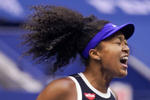 FILE - In this Sept. 12, 2020, file photo, Naomi Osaka, of Japan, reacts during the women's singles final against Victoria Azarenka, of Belarus, during the U.S. Open tennis tournament in New York.  Osaka has been selected by The Associated Press as the Female Athlete of the Year. (AP Photo/Seth Wenig, File)