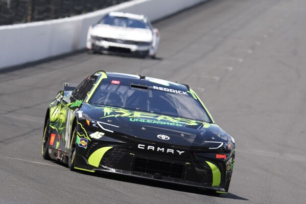 Tyler Reddick drives into a turn during a practice session for the NASCAR Cup Series auto race at Indianapolis Motor Speedway, Friday, July 19, 2024, in Indianapolis. (ĢӰԺ Photo/Darron Cummings)