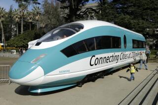 FILE - A full-scale mock-up of a high-speed train, is displayed at the Capitol in Sacramento, Calif., on Feb. 26, 2015. The California High-Speed Rail Authority's biennial business plan, released Tuesday, Feb. 8, 2022, shows the estimated cost of the project rising by about $5 billion, compared to the 2020 plan, up to as much as $105 billion. (AP Photo/Rich Pedroncelli, File)