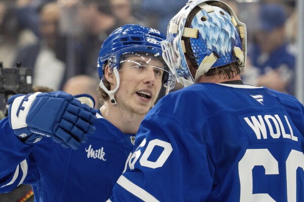 Toronto Maple Leafs' Mitch Marner (16) celebrates with goaltender Joseph Woll (60) after defeating the Florida Panthers in NHL playoff hockey action in Toronto on Wednesday, May 7, 2025. (Frank Gunn/The Canadian Press via AP)
