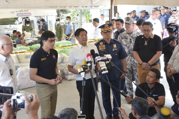 In this handout photo provided by the Batangas Public Information Office, Philippine President. Ferdinand Jr., third from left, talks to reporters as he visits Alitagtag town in Batangas province, Philippines on Tuesday April 16, 2024. Marcos Jr said Tuesday police seized the largest haul of methamphetamine in the country in years without anybody killed, in a subtle criticism of his predecessor's notoriously deadly crackdown on illegal drugs. (Batangas Public Information Office via AP)