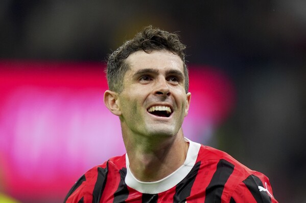 AC Milan's Christian Pulisic celebrates after scoring their second goal of the game during the Serie A soccer match between Milan and Bologna at San Siro Stadium in Milan, Italy, Friday May 9, 2025. (Spada/LaPresse via AP)