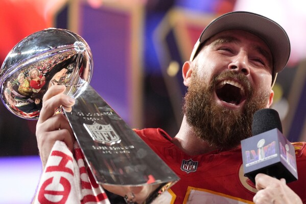 Kansas City Chiefs tight end Travis Kelce celebrates with the trophy after the win in overtime during the NFL Super Bowl 58 football game against the San Francisco 49ers on Sunday, Feb. 11, 2024, in Las Vegas. The Chiefs won 25-22. (APPhoto/Ashley Landis)