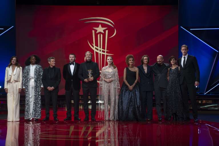 The jury of the Marrakech International Film Festival pose with Mads Mikkelsen, center left, after receiving his tribute award, on the opening ceremony, in Morocco, Friday, Nov. 24, 2023. (AP Photo/Mosa'ab Elshamy)