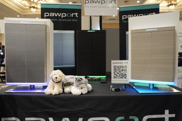The Pawport pet door is on display at the Pawport booth at Pepcom ahead of the CES tech show Monday, Jan. 8, 2024, in Las Vegas. The pet door utilizes a tag attached to a pet's collar to signal the door to open. (AP Photo/John Locher)