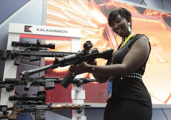 FILE - A visitor handles a gun at an exhibition by the Kalashnikov company on the sidelines of the Russia-Africa summit in the Black Sea resort of Sochi, Russia on Oct. 24, 2019. Amid a worldwide chorus of condemnation against Russia's war on Ukraine, Africa has remained mostly quiet — a reminder of the Kremlin's considerable influence over the continent. (Sergei Chirikov, Pool Photo via AP, File)