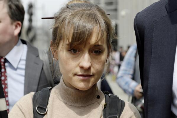 FILE-  In this April 8, 2019 file photo, actor Allison Mack leaves Brooklyn federal court in New York after pleading guilty to racketeering charges in a case involving a cult-like group based in upstate New York called NXIVM.  Mack, who played a key role in the cultlike group NXIVM, has surrendered to a California prison to serve her sentence in a New York case against the group’s spiritual leader. (AP Photo/Mark Lennihan, File)