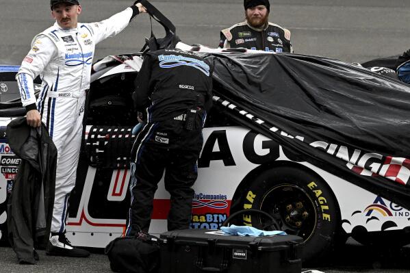 Austin Dillon stands next to his car after returning to the pits when the NASCAR Xfinity Series race was postponed, Saturday, Feb. 25, 2023, at Auto Club Speedway in Fontana, Calif. (Will Lester/The Orange County Register via AP)