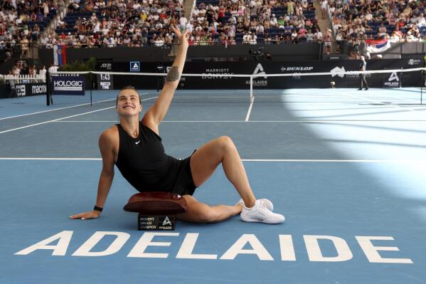 Aryna Sabalenka of Belarus gestures as she was posing for a photo after she defeated Linda Noskova of the Czech Republic in the women’s final at the Adelaide International tennis tournament in Adelaide, Australia, Sunday, Jan. 8, 2023. (AP Photo/Kelly Barnes)
