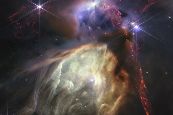 The first anniversary image released Wednesday, July 12, 2023, by Space Telescope Science Institute Office of Public Outreach, shows NASA’s James Webb Space Telescope displaying a star birth like it’s never been seen before, full of detailed, impressionistic texture. The subject is the Rho Ophiuchi cloud complex, the closest star-forming region to Earth. (NASA, ESA, CSA, STScI, Klaus Pon via AP)
