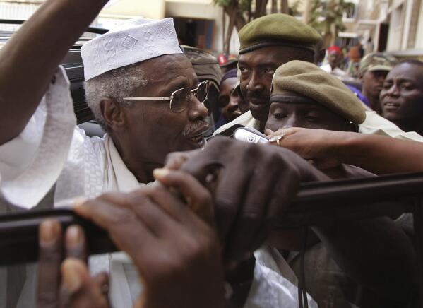 FILE - In this Friday, Nov. 25, 2005 file photo, former Chad dictator Hissene Habre gestures as he leaves a court in Dakar, Senegal. Chad's former dictator Hissene Habre, whose government was accused of killing tens of thousands and became the first former head of state to be convicted of crimes against humanity by an African court, has died in Senegal of COVID-19, aged 79, according to Senegalese officials Tuesday, Aug. 24, 2021. (AP Photo/Schalk van Zuydam, File)