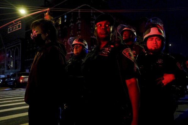 New York Police escort protesters onto a bus after making arrests during a standoff between police and demonstrators outside the City College of New York, Wednesday, May 1, 2024, in New York. Police have swept through other campuses across the U.S. over the last two weeks, leading to confrontations and more than 1,000 arrests nationwide. (AP Photo/Julius Motal)