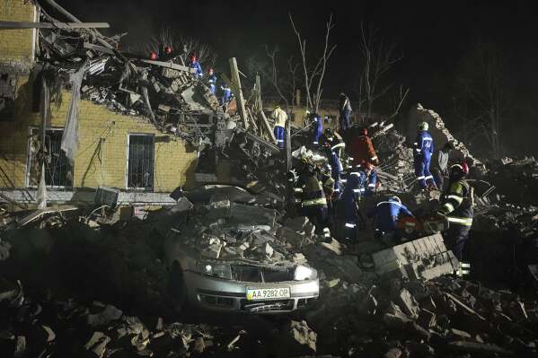 Ukrainian search personnel clear the rubble after a Russian ballistic missile attack in Kyiv, Ukraine, early Thursday, April 24, 2025. (AP Photo/Efrem Lukatsky)