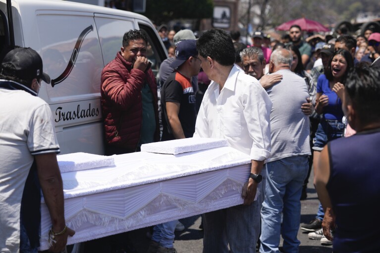 Funeral workers carry the coffin that contain the remains of an 8-year-old girl, in Taxco, Mexico, Thursday, March 28, 2024. The 8-year-old girl disappeared Wednesday; her body was found on a road on the outskirts of the city early Thursday. (AP Photo/Fernando Llano)