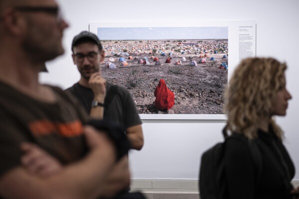 Jonathan Fointaine's "The Nomad's Final Journey", which was awarded with an honorable mention by the World Press Photo jury, is on display at the opening of the World Press Photo 2023 exhibition at the Hungarian National Museum, in Budapest, Hungary, Thursday, Sept. 21, 2023. Minors under 18 have been barred from visiting this year’s World Press Photo exhibition in Hungary after the government determined that some of its photos violate a contentious law restricting LGBTQ+ content. (Szigetvary Zsolt/MTI via AP)