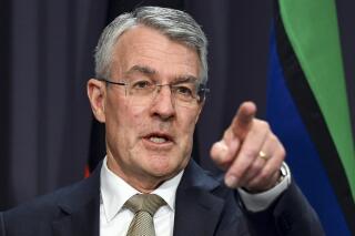 Attorney-General Mark Dreyfus gestures at a press conference at Parliament House in Canberra, Australia, Tuesday, Sept. 27, 2022. Dreyfus said on Tuesday he will introduce legislation to create the National Anti-Corruption Commission to Parliament on Wednesday. (Mick Tsikas/AAP Image via AP)