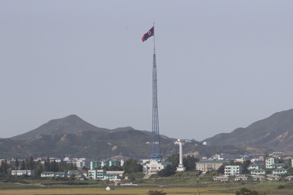 FILE - A North Korean flag flutters in the wind atop a 160-meter (525-foot) tower in the North's Kijong-dong village near the truce village of Panmunjom in the Demilitarized Zone in Paju, South Korea on Sept, 28, 2017. North Korea hurled misogynistic insults Wednesday, Aug. 2, 2023 at a newly confirmed United States special envoy to monitor the country’s human rights issues and warned of unspecified security consequences if Washington continues to criticize its human rights conditions. (AP Photo/Lee Jin-man, File)