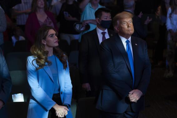 FILE - President Donald Trump attends church at International Church of Las Vegas with counselor Hope Hicks, left, Sunday, Oct. 18, 2020, in Las Vegas, Nev. Hicks, Trump's former spokeswoman, met Monday, March 6, 2023, with Manhattan prosecutors investigating hush-money payments made on the ex-president's behalf — the latest member of the Republican's inner circle to be questioned in the renewed probe. (AP Photo/Alex Brandon, File)