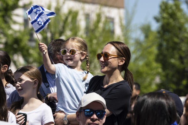 People gathered in Huyler Park celebrate the release of American hostage Edan Alexander from Hamas on Monday, May 12, 2025, in Tenafly, N.J. (AP Photo/Stefan Jeremiah)