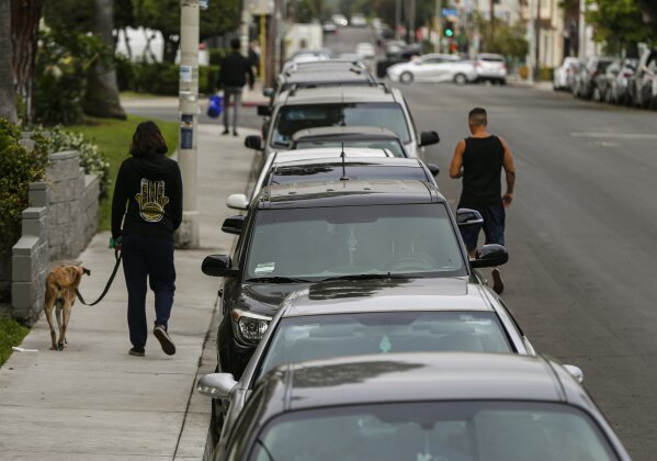 In this Friday, May 22, 2020, a line of vehicles are parked in Los Angeles. The coronavirus hasn't been kind to car owners. With more people than ever staying home to lessen the spread of COVID-19,...
