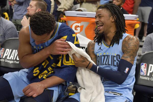 Memphis Grizzlies guards Desmond Bane, left, and Ja Morant (12) laugh on the bench during the second half of Game 5 of the team's first-round NBA basketball playoff series against the Los Angeles Lakers on Wednesday, April 26, 2023, in Memphis, Tenn. (AP Photo/Brandon Dill)