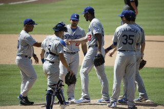 
              FILE - In this Sept. 2, 2017, file photo, Los Angeles Dodgers relief pitcher Wilmer Font, center, hands the ball to manager Dave Roberts as he is relieved during the sixth inning of a baseball game against the San Diego Padres, in San Diego. No need for catchers to worry about getting they're running in, especially during the postseason. They are taking so many trips to the mound for discussions, the average time of a nine-inning game is 3 hours, 32 minutes during the postseason, up 18 minutes since 2015. (AP Photo/Jae C. Hong, File)
            