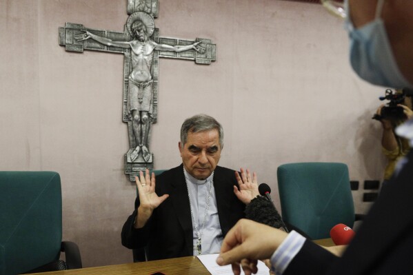FILE - Cardinal Angelo Becciu talks to journalists during press conference in Rome on Sept. 25, 2020. Lawyers for the once-powerful cardinal have accused Vatican prosecutors of being 