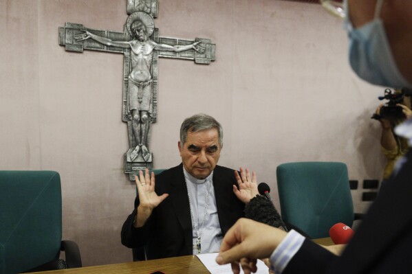 FILE - Cardinal Angelo Becciu talks to journalists during press conference in Rome on Sept. 25, 2020. Lawyers for the once-powerful cardinal have accused Vatican prosecutors of being "prisoners to their completely shattered theory" in closing arguments of a two-year trial. Becciu is on trial along with nine other people in a case that is focused on the Vatican's 350 million-euro investment in a London property. (AP Photo/Gregorio Borgia, File)