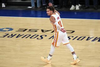 FILE - In this June 2, 2021, file photo, Atlanta Hawks guard Trae Young waves to the crowd after making a 3-point shot against the New York Knicks in the fourth quarter of Game 5 of an NBA basketball first-round playoff series in New York. Young made a surprise appearance at "WWE Friday Night SmackDown," returning to the arena where he led the Hawks to an NBA playoff victory over the Knicks.Wearing a gray Hawks hoodie, Young was the perfect wrestling villain. (Wendell Cruz/Pool Photo via AP, File)