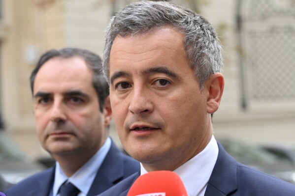 FILE - French Interior Minister Gerald Darmanin, right, talks to the media after a meeting on Oct. 9, 2023, in Paris. French police arrested a man who targeted passersby in Paris on Saturday night, Dec. 2, 2023, killing a German tourist with a knife and injuring two others, France's Interior Minister Darmanin said.(Bertrand Guay, Pool via AP, File)