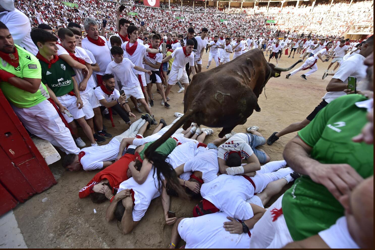 Pictured: Runners thrown into the air during Pamplona bull festival