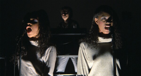 This image released by A24 shows, from left, Ednah Holt, Jerry Harrison, and Lynn Mabry in a scene from "Stop Making Sense." (Jordan Cronenweth/A24 via AP)