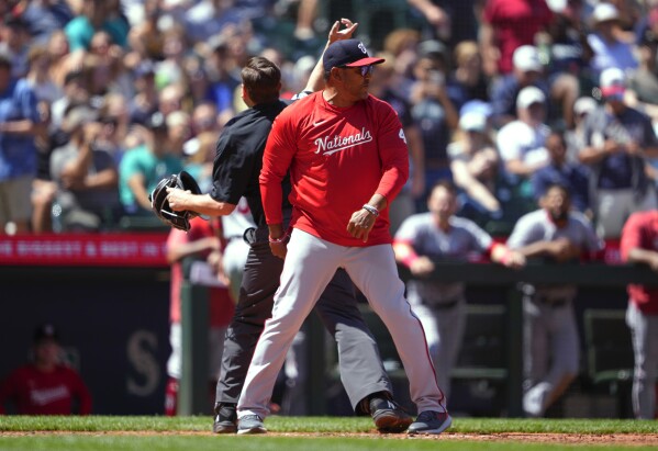 Washington Nationals manager Dave Martinez is ejected by home plate umpire Derek Thomas after Nationals' Keibert Ruiz was called out for running out of the baseline during the sixth inning of the team's baseball game against the Seattle Mariners on Wednesday, June 28, 2023, in Seattle. (AP Photo/Lindsey Wasson)