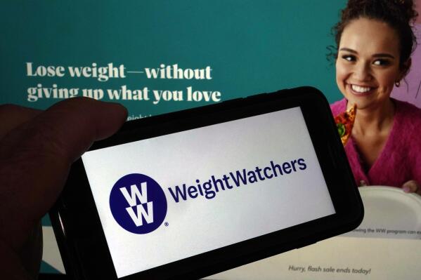 This image shows the logo of WeightWatchers on a mobile phone, and the company's website, in New York, Tuesday, March 7, 2023. WeightWatchers shares soared Tuesday after the company said it was getting into the prescription drug weight loss business with the acquisition of Sequence. (AP Photo/Richard Drew)