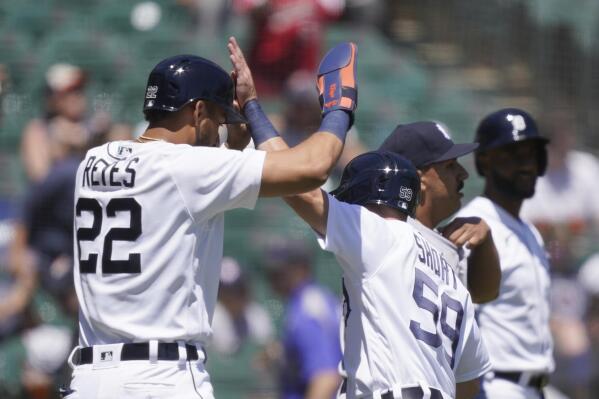 Detroit Tigers' Victor Reyes (22) high fives teammate Zack Short after they both scored on Willi Castro's double during the third inning of a baseball game against the New York Yankees, Sunday, May 30, 2021, in Detroit. (AP Photo/Carlos Osorio)