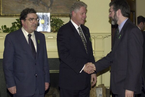 President Clinton greets Sinn Fein President Gerry Adams, right, as Social Democratic Labor Party leader John Hume stands at left, in the Roosevelt Room of the White House in Washington, Friday, March 17, 2000. (AP Photo/Susan Walsh, File)