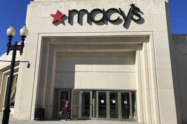 FILE - A shopper exits Macy's at the Woodfield Old Orchard Shopping Center in Skokie, Ill., Saturday, Feb. 19, 2022. Macy's reports earnings on Tuesday, Aug. 12, 2023. (AP Photo/Nam Y. Huh, File)