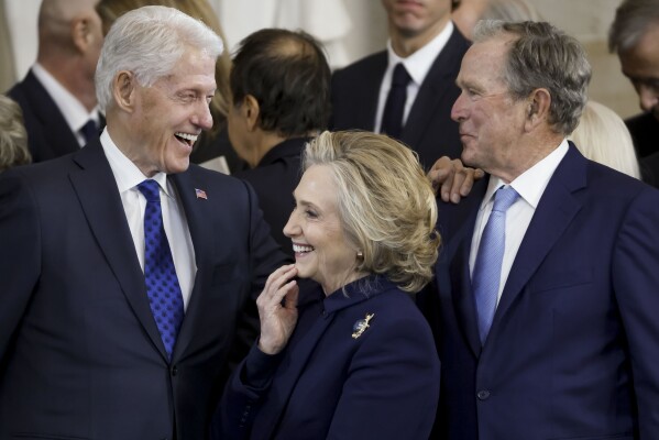 From left, former President Bill Clinton, former Secretary of State Hillary Clinton, and former President George W. Bush, speak following the 60th Presidential Inauguration for President Donald Trump, in the Rotunda of the U.S. Capitol in Washington, Monday, Jan. 20, 2025. (Shawn Thew/Pool photo via AP