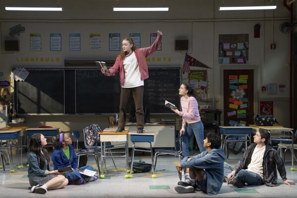 This image released by O&M/DKC shows, from left, Amelia Yoo, Morgan Scott, Sadie Sink, Fina Strazza, Nihar Duvvuri and Hagan Oliveras during a performance of "John Proctor Is the Villain" in New York. (Julieta Cervantes/O&M/DKC via AP)