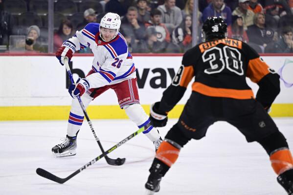 New York Rangers' Jimmy Vesey (26) takes a shot to score a goal during the third period of an NHL hockey game against the Philadelphia Flyers, Saturday, Dec. 17, 2022, in Philadelphia. (AP Photo/Derik Hamilton)