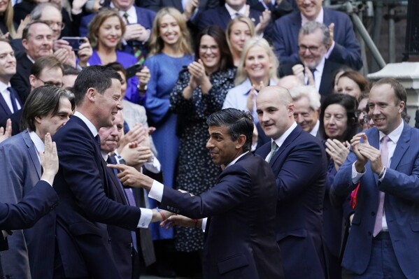 FILE - Rishi Sunak, centre, gestures as conservative MPs greet him after arriving at the Conservative Party leadership contest at the Conservative party Headquarters in London, Oct. 24, 2022. (AP Photo/Alberto Pezzali, File)