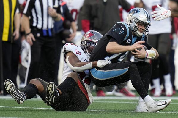 Carolina Panthers quarterback Sam Darnold is sacked by Tampa Bay Buccaneers inside linebacker Kevin Minter during the second half of an NFL football game Sunday, Dec. 26, 2021, in Charlotte, N.C. (AP Photo/Rusty Jones)