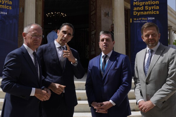 Cyprus' interior minister Konstantinos Ioannou, second left, talks with his counterparts Austria's Gerhard Karner, left, Czech's Vít Rakusan, right, and Greece's Minister Of Immigration and Asylum Dimitris Kairides, second right, during the Ministerial Summit Migration and Syria Dynamics in capital Nicosia, Cyprus, Friday, May 17, 2024. The governments of eight European Union member states say the situation inside Syria should be re-evaluated to allow for voluntary returns of Syrian refugees back to their homeland. (AP Photo/Petros Karadjias)