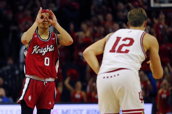 Rutgers guard Derek Simpson (0) reacts after making a 3-point basket against Indiana forward Miller Kopp (12) during the second half of an NCAA college basketball game in Piscataway, N.J., Saturday, Dec. 3, 2022. (AP Photo/Noah K. Murray)